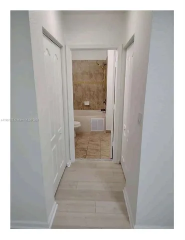 a bathroom with a toilet and a bathtub