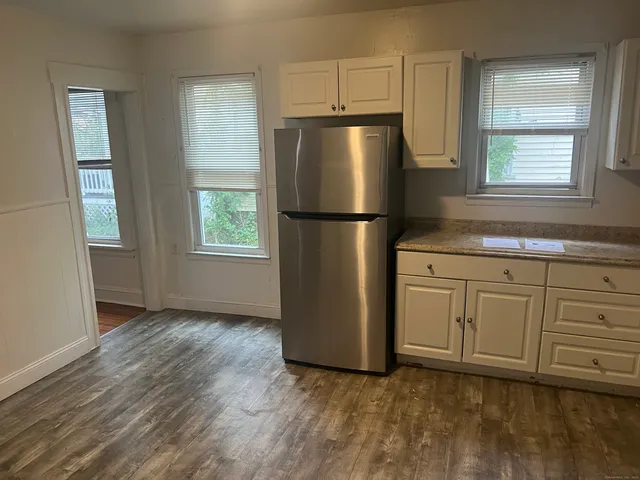 a kitchen with stainless steel appliances a refrigerator sink and cabinets