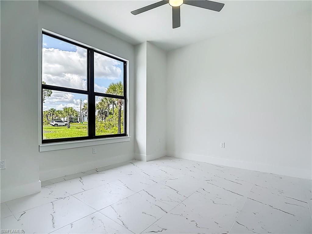 2707 36th Avenue Southeast Naples, FL 34117 - Photo 25 of 50 Unfurnished room with marble finish floors and ceiling fan
