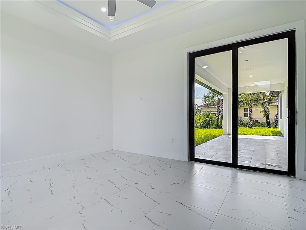 2707 36th Avenue Southeast Naples, FL 34117 - Photo 31 of 50 Empty room with marble finish floors, ceiling fan, and recessed lighting