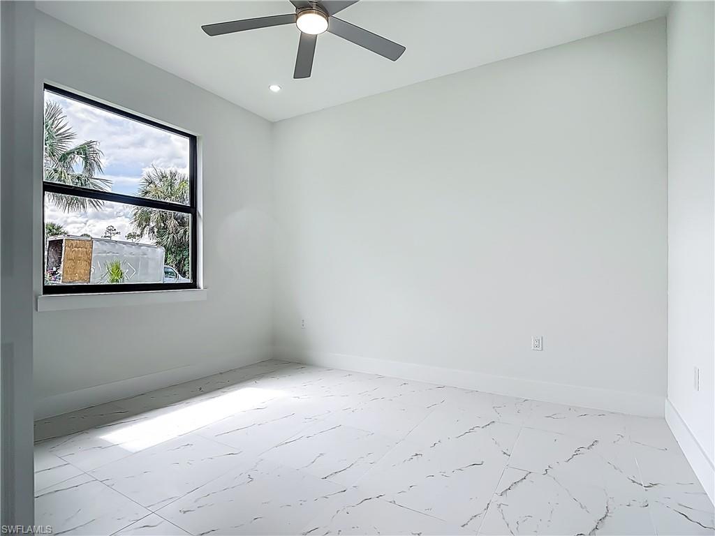 2707 36th Avenue Southeast Naples, FL 34117 - Photo 38 of 50 Unfurnished room with recessed lighting, ceiling fan, and marble finish flooring