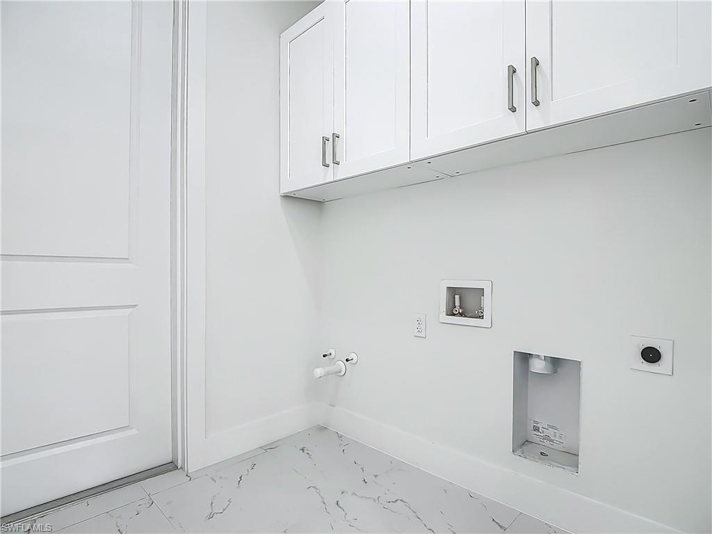 2707 36th Avenue Southeast Naples, FL 34117 - Photo 41 of 50 Laundry area featuring cabinet space, light marble finish flooring, hookup for a gas dryer, hookup for a washing machine, and hookup for an electric dryer