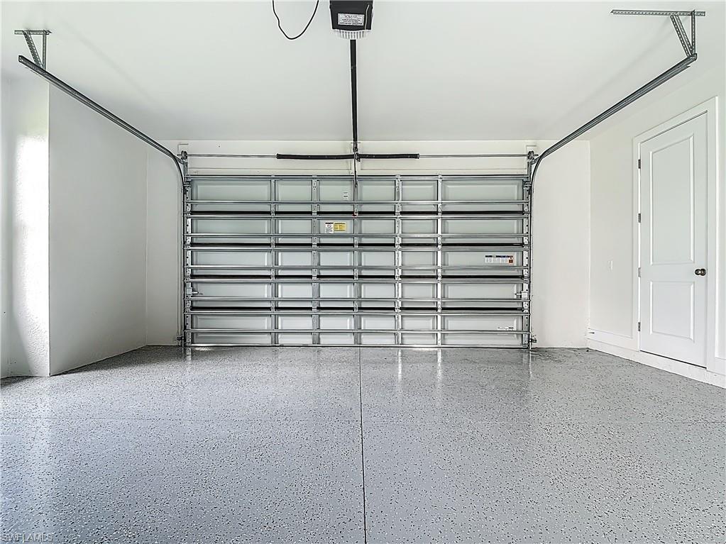 2707 36th Avenue Southeast Naples, FL 34117 - Photo 42 of 50 Garage featuring a garage door opener