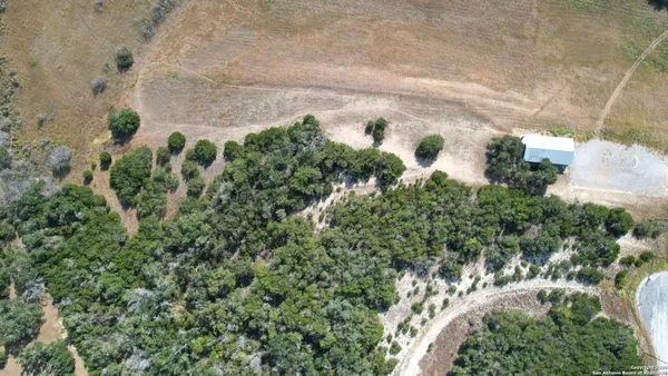 an aerial view of a residential houses with outdoor space