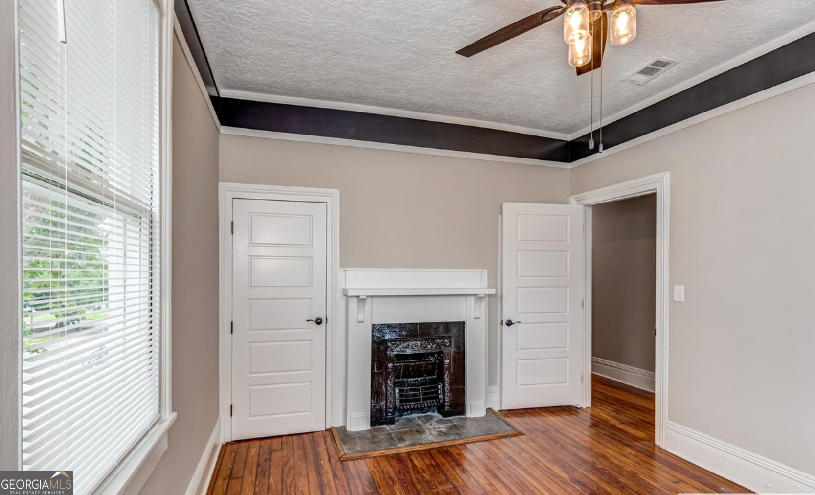 136 Broad Street Augusta, GA 30901 - Photo 3 of 8 a view of a livingroom with wooden floor and a ceiling fan