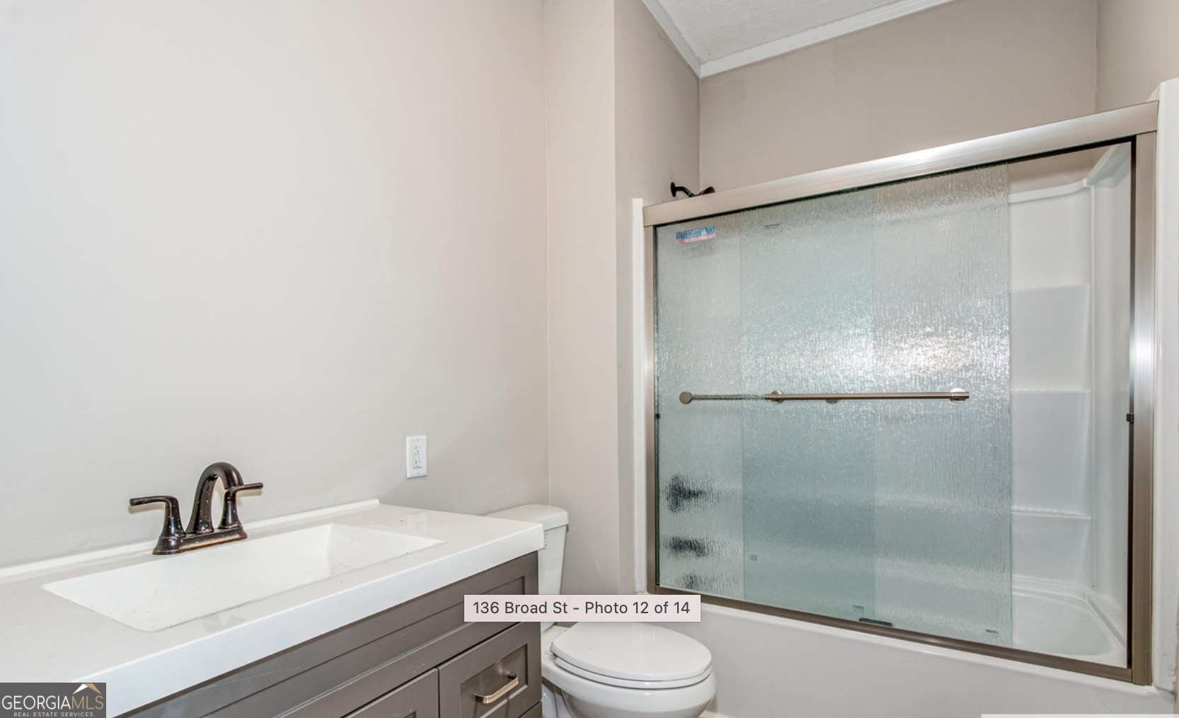 136 Broad Street Augusta, GA 30901 - Photo 7 of 8 a bathroom with a sink toilet a mirror and shower