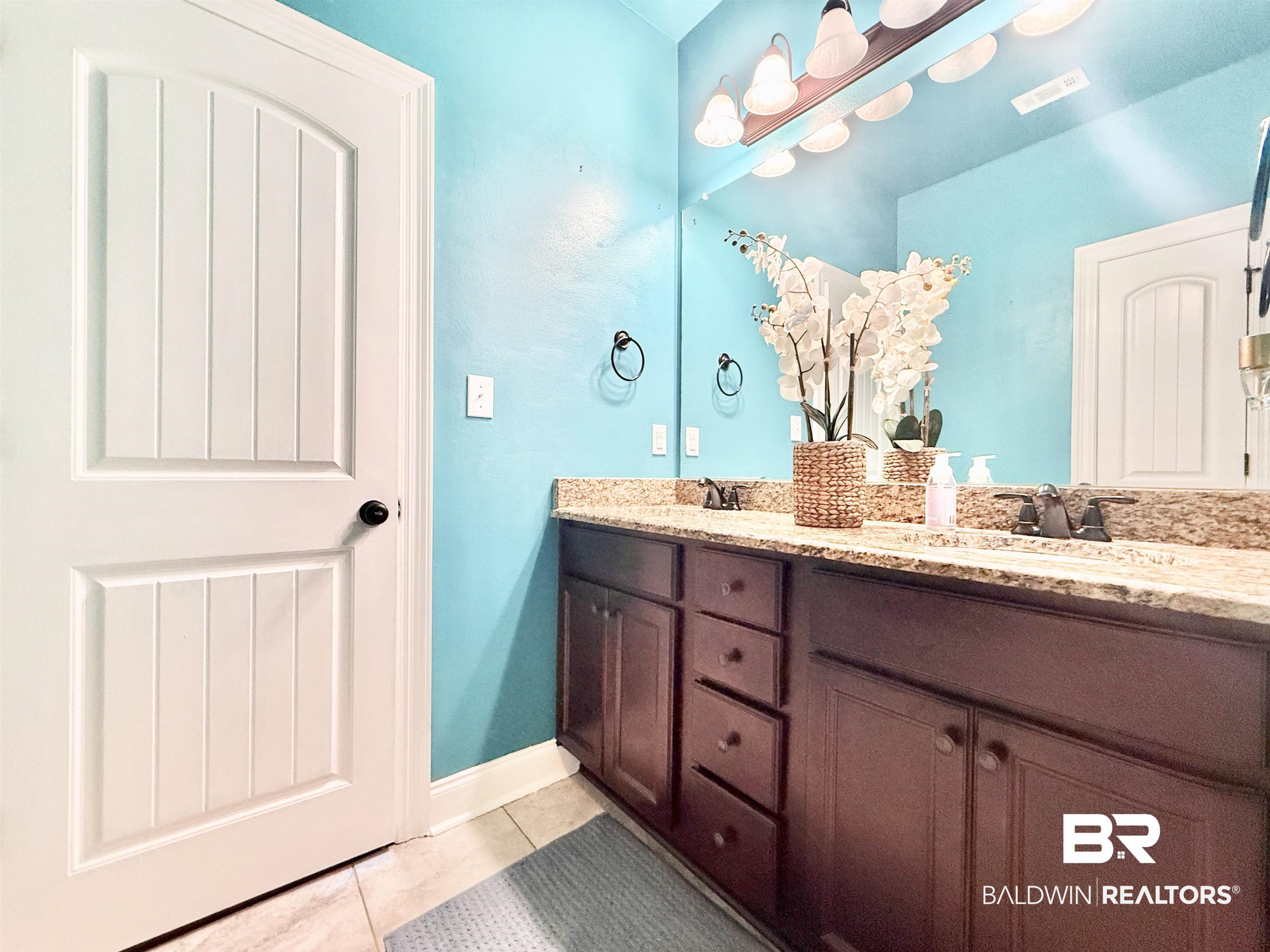 7011 Rocky Rd Loop Gulf Shores, AL 36542 - Photo 33 of 66 Bathroom featuring light tile patterned floors and double vanity