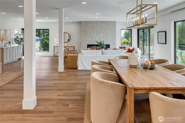 a living room with furniture wooden floor and a large window