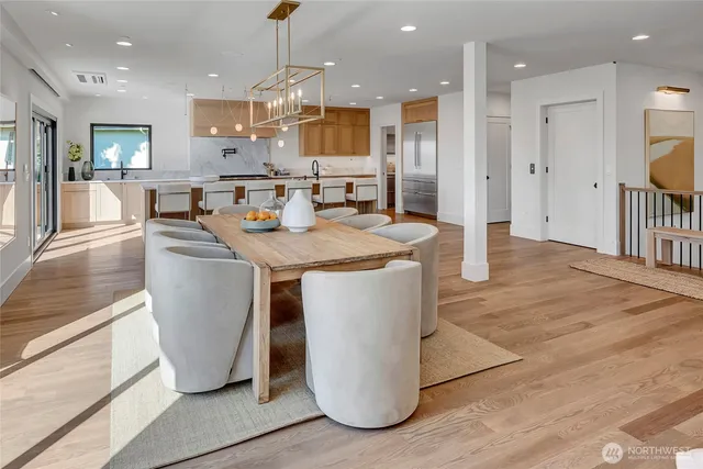 a kitchen with stainless steel appliances granite countertop a refrigerator a sink and a stove