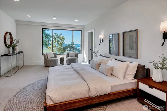 a bedroom with a large bed and a large window