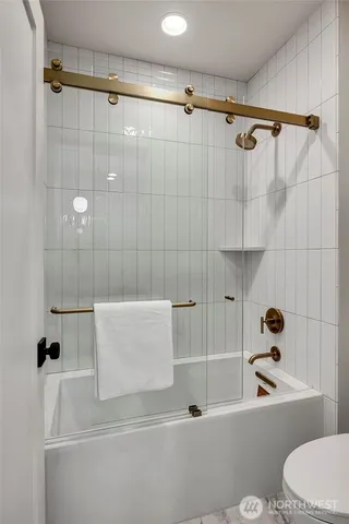 a bathroom with a shower a toilet and a shower