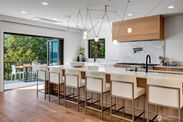 a kitchen with a dining table chairs sink and cabinets