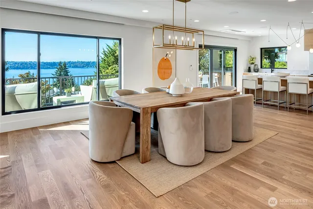 a living room with a large window and chandelier