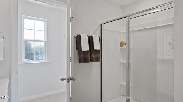 a bathroom that has a glass shower door