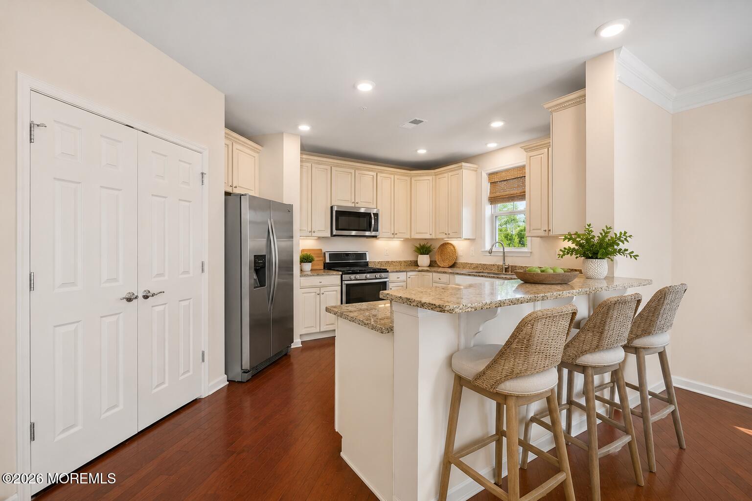 2201 River Road, Unit 4207 Point Pleasant, NJ 08742 - Photo 4 of 34 a kitchen with stainless steel appliances kitchen island granite countertop a refrigerator and a stove top oven