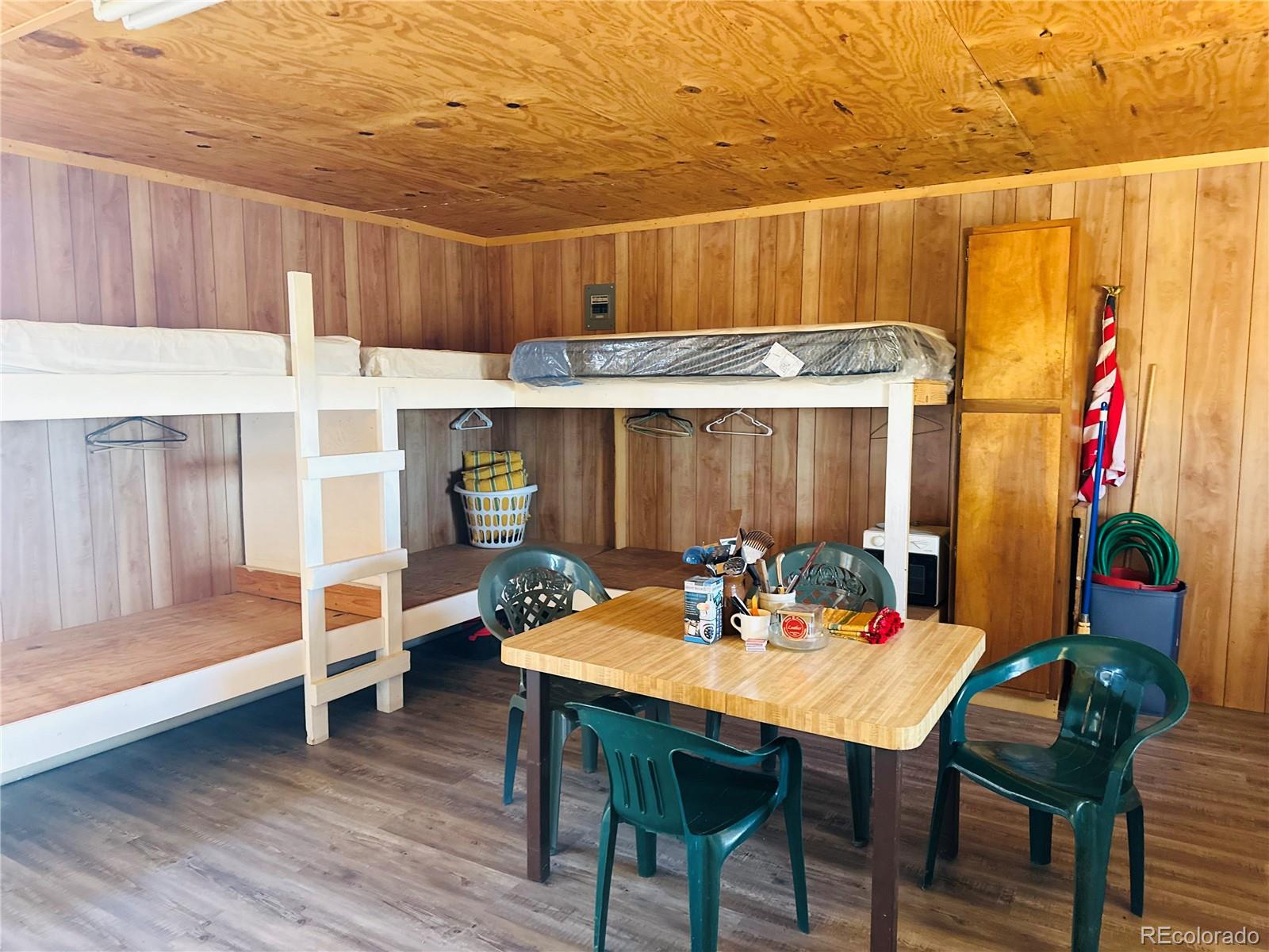 0 County Road La Jara, CO 81140 - Photo 17 of 26 a outdoor dining space with furniture and wooden floor