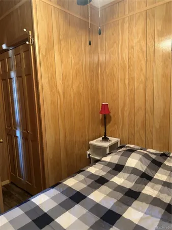 a bedroom with a bed and a mirror