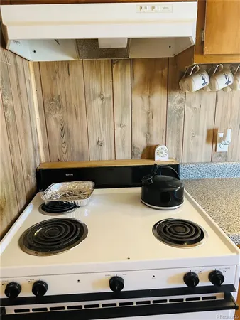 a stove top oven sitting inside of a kitchen
