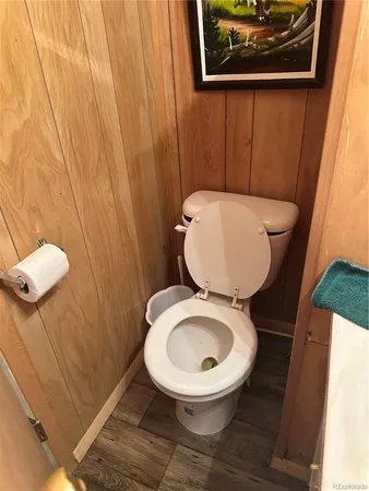 a bathroom with a toilet and a mirror
