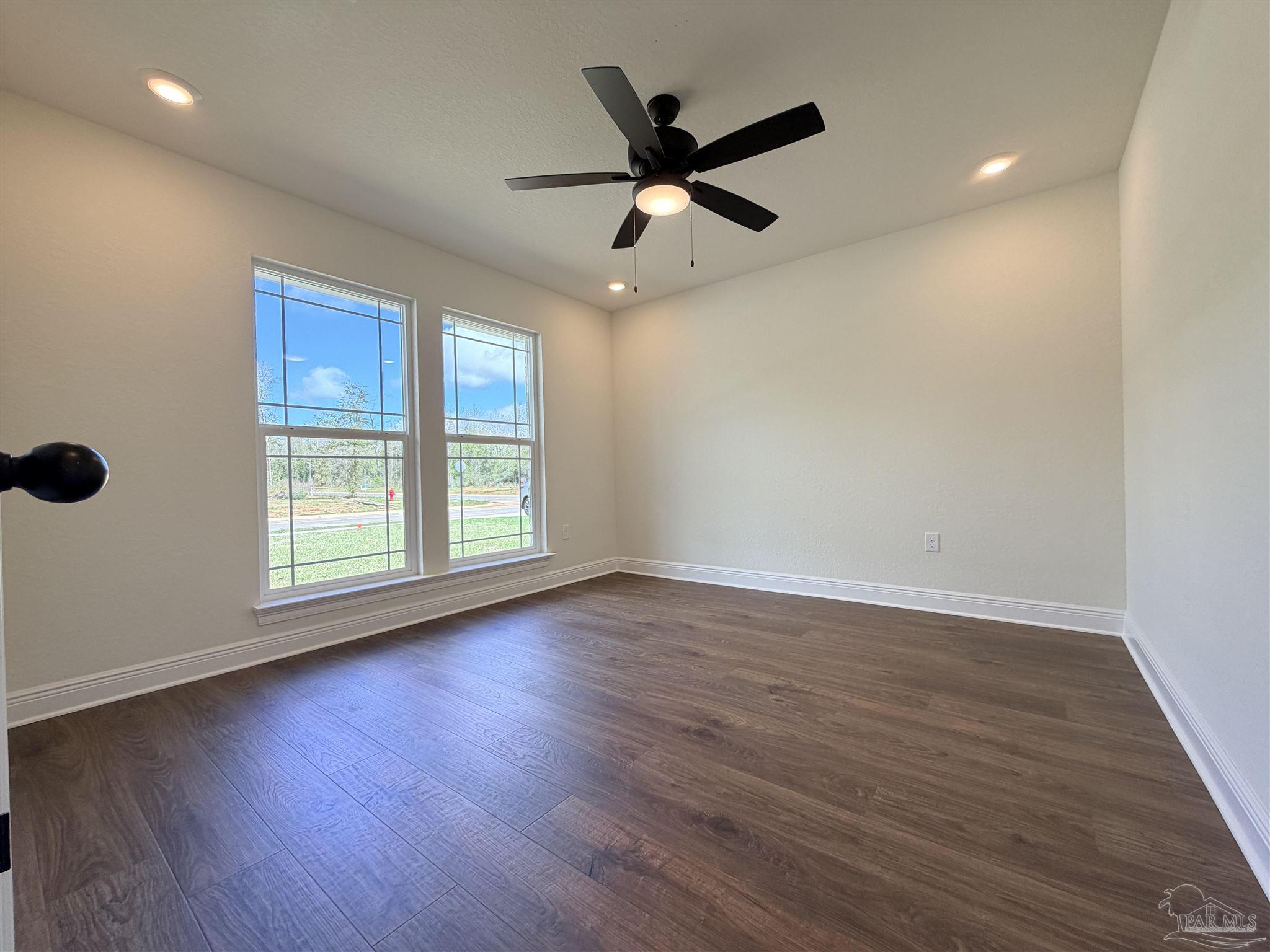 5263 Wahoo Road Milton, FL 32583 - Photo 19 of 25 a view of an empty room with wooden floor and a window
