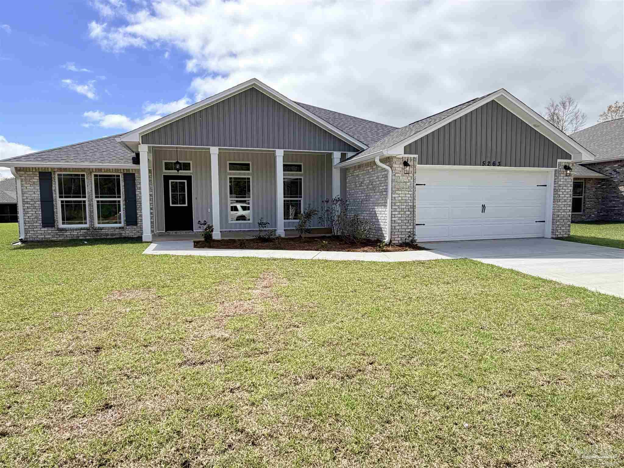 5263 Wahoo Road Milton, FL 32583 - Photo 2 of 25 a front view of a house with a yard