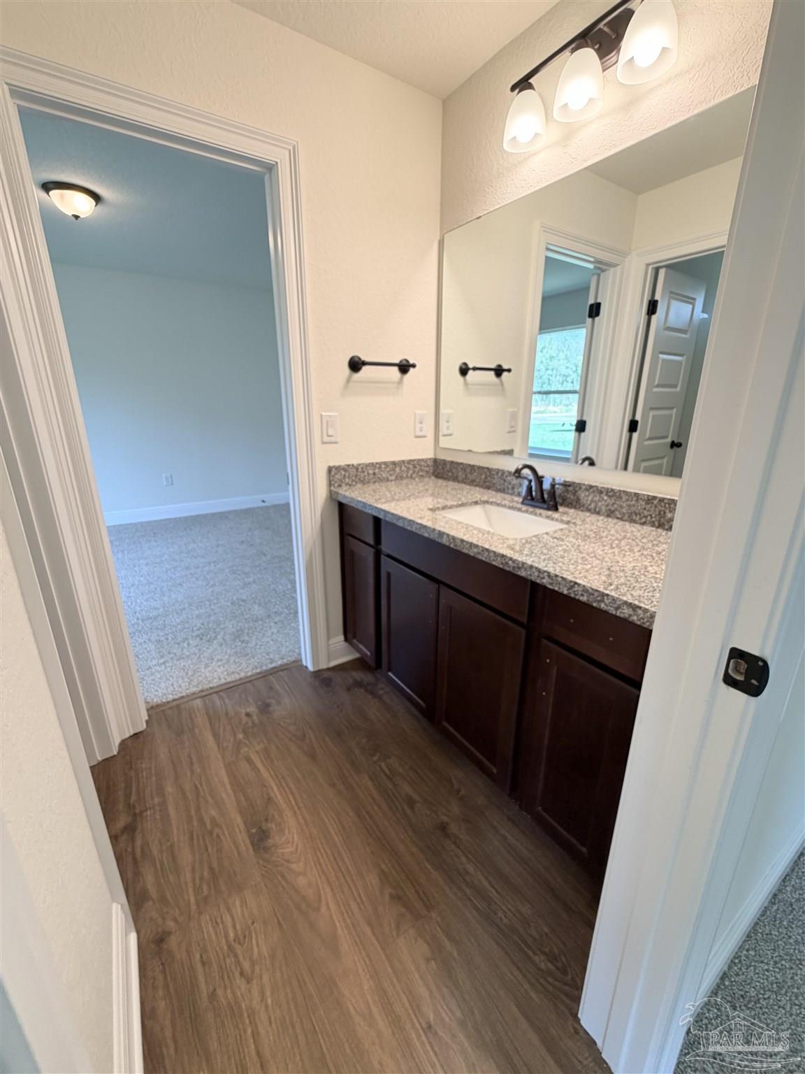 5263 Wahoo Road Milton, FL 32583 - Photo 22 of 25 a bathroom with a sink and a mirror