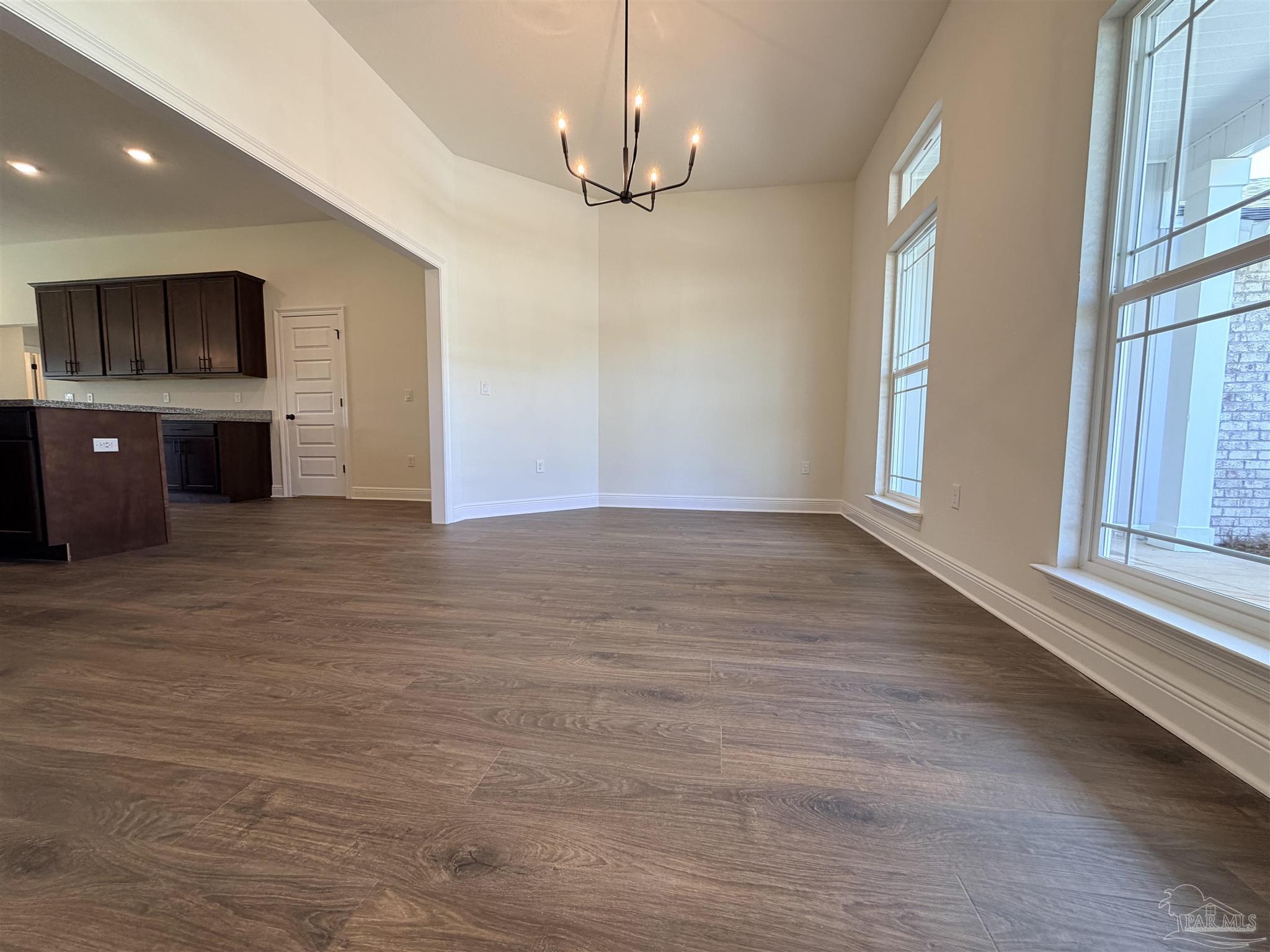 5263 Wahoo Road Milton, FL 32583 - Photo 5 of 25 a view of an empty room with a window and kitchen view