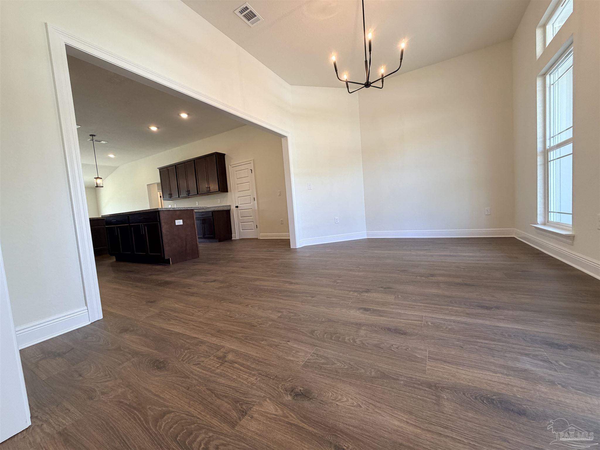 5263 Wahoo Road Milton, FL 32583 - Photo 6 of 25 an empty room with wooden floor and windows