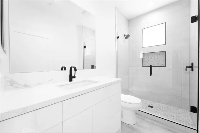 a bathroom with a sink toilet and shower