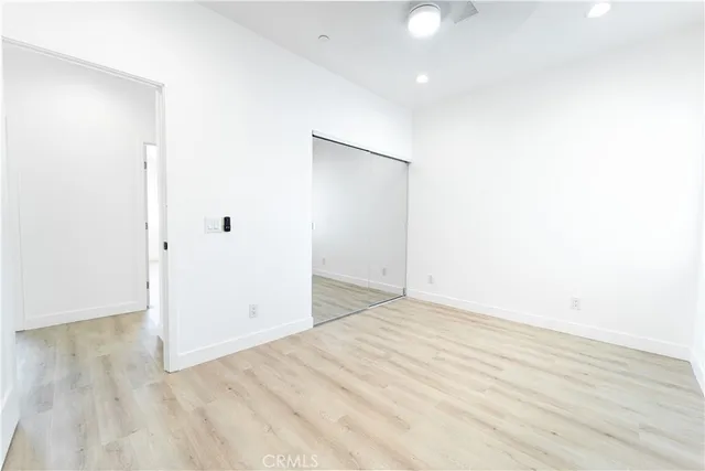 an empty room with wooden floor