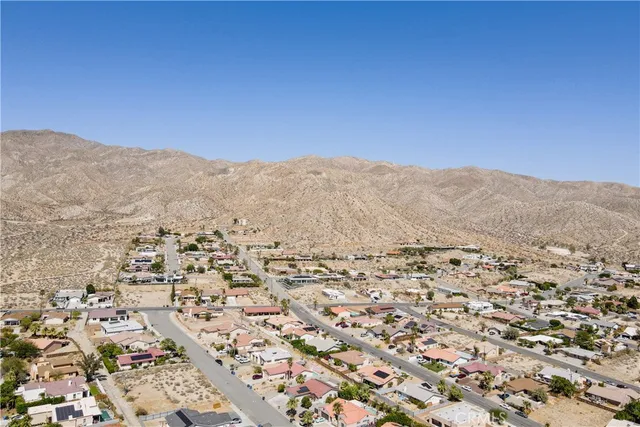 an aerial view of houses with a street