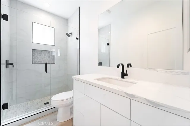 a bathroom with a sink toilet and shower