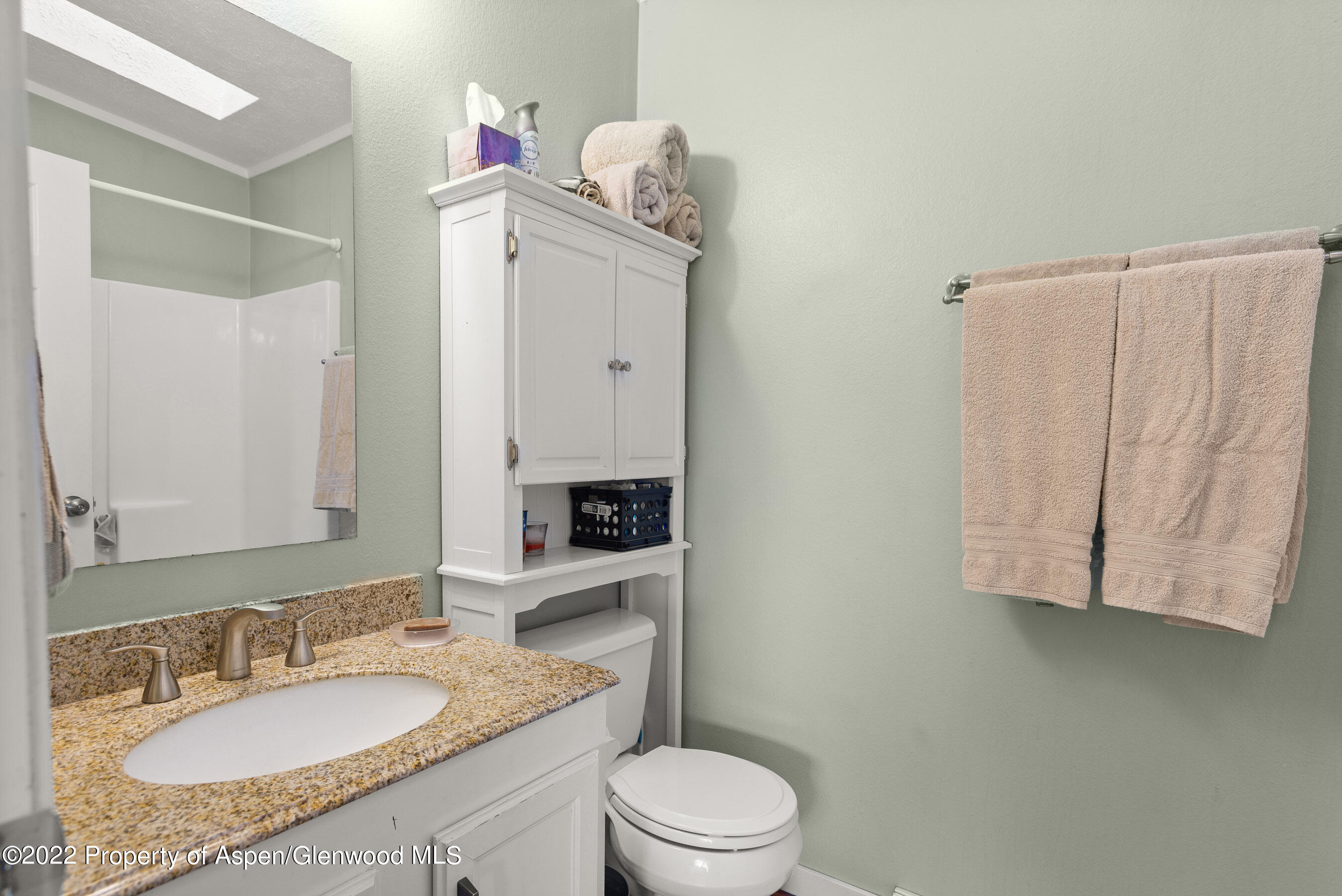 130 Swiss Lane Road Rifle, CO 81650 - Photo 15 of 39 a bathroom with a granite countertop sink vanity mirror and toilet