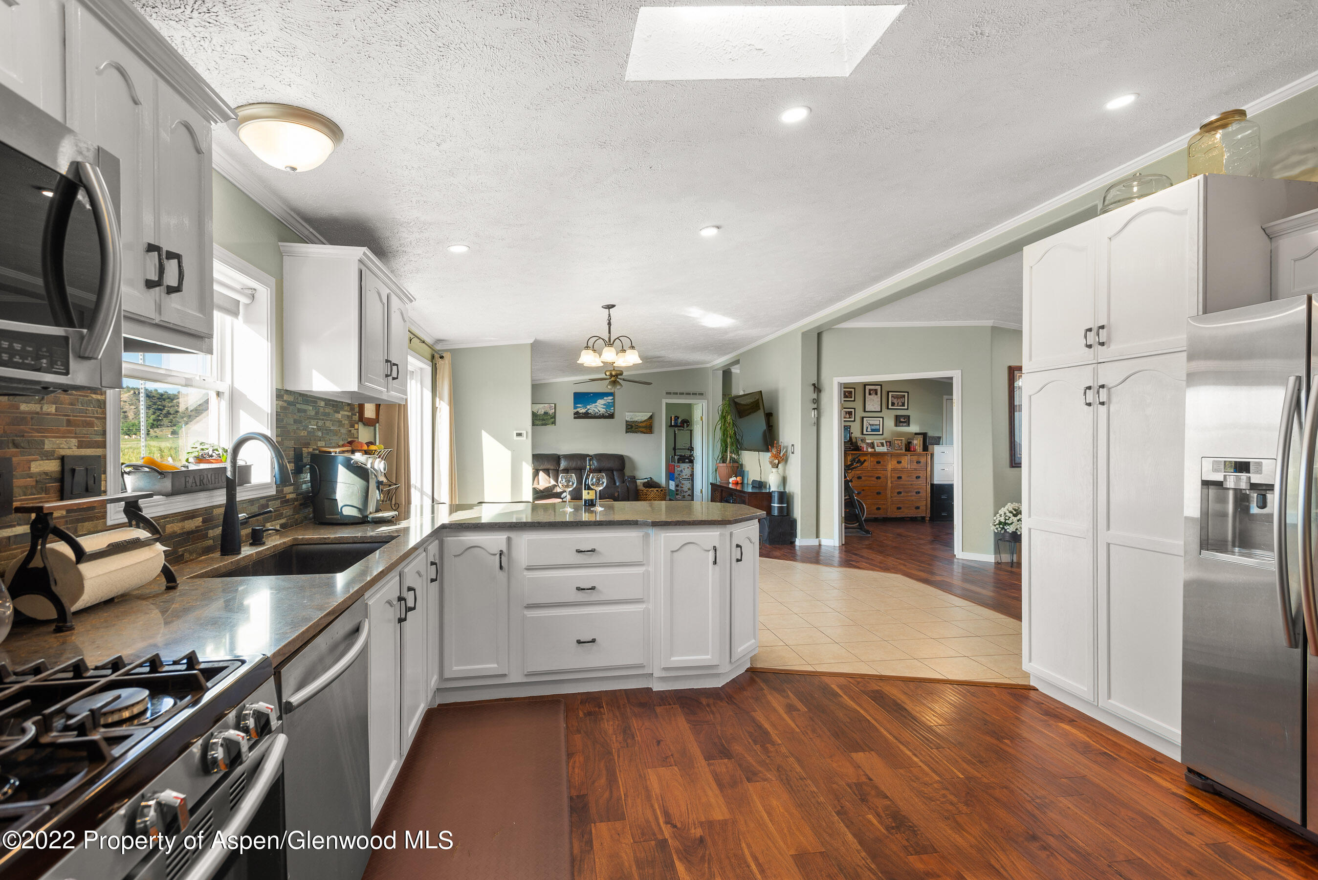 130 Swiss Lane Road Rifle, CO 81650 - Photo 6 of 39 a kitchen with stainless steel appliances granite countertop a sink stove and refrigerator