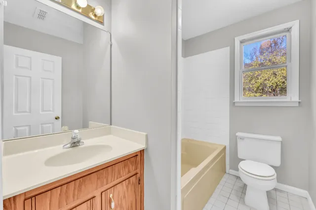 a bathroom with a sink a toilet and bathtub