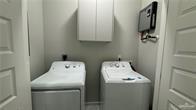 906 Hidden Hls Street, Unit 1 Mission, TX 78572 - Photo 5 of 9 a utility room with dryer and washer