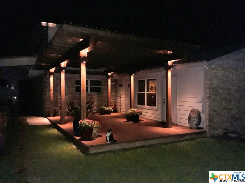 a view of a house with backyard sitting area and porch