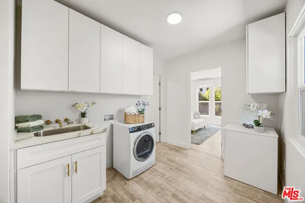 a view of a kitchen with sink washer and dryer