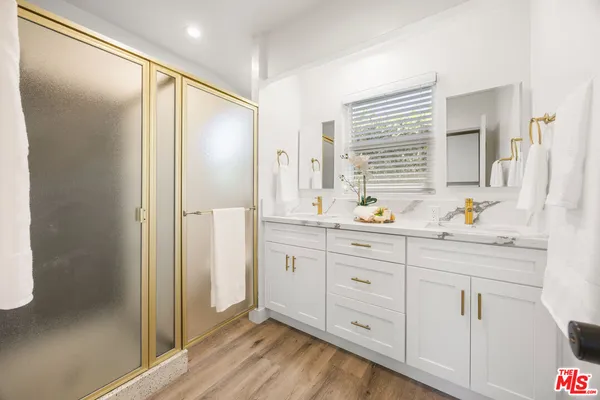 a bathroom with a double vanity sink and mirror