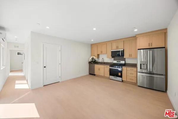 a kitchen with stainless steel appliances granite countertop a refrigerator oven a sink and dishwasher