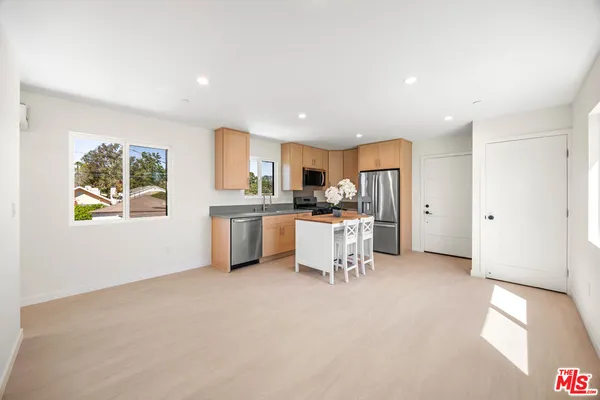 a kitchen with stainless steel appliances refrigerator sink and cabinets