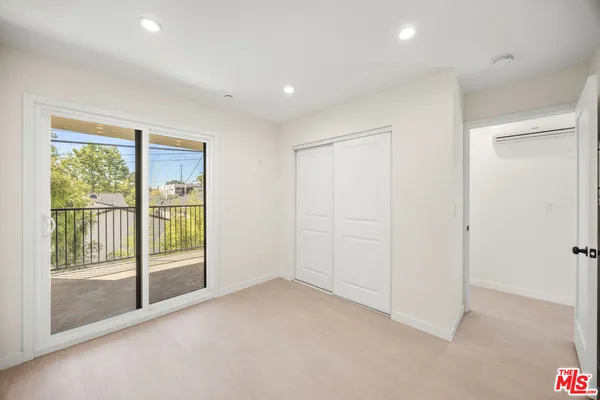 a view of an empty room with glass door