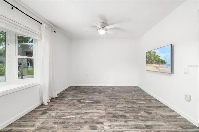 wooden floor in an empty room with a window