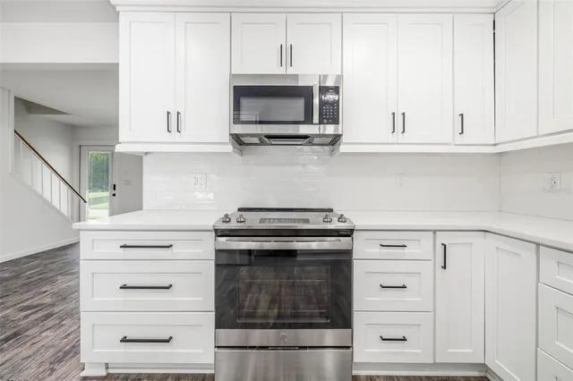 a stove top oven sitting inside of a kitchen