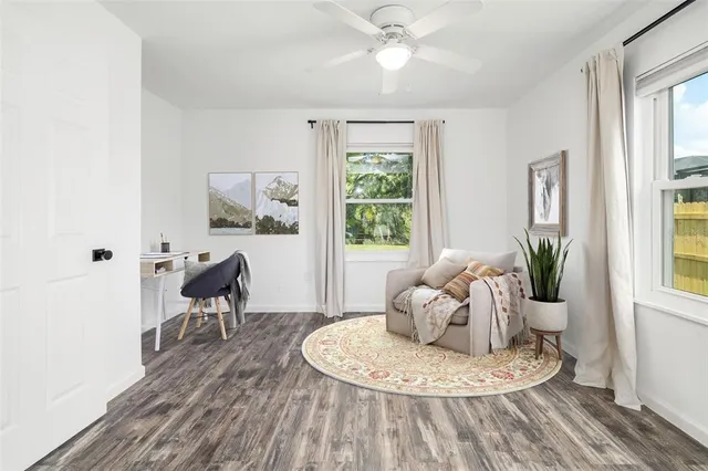 a living room with furniture and a potted plant