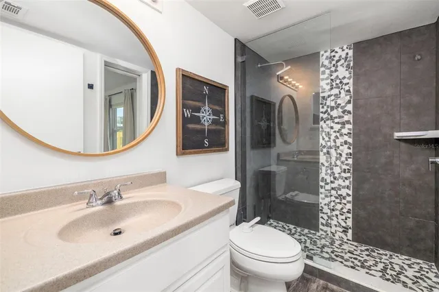a bathroom with a sink toilet and shower