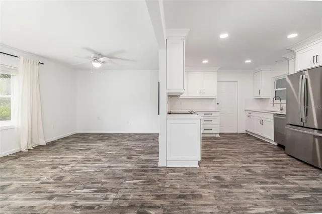 a kitchen with white cabinets and white appliances