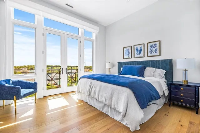 a spacious bedroom with a bed and a large window