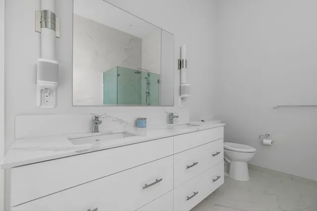 a bathroom with a double vanity sink and a mirror