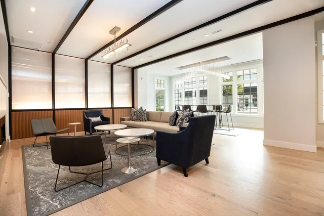 a living room with furniture potted plant and a large window